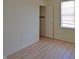 Bedroom featuring a window and closet with wood-look flooring throughout at 12326 River Valley Dr, Fishers, IN 46037