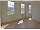 Bedroom showcasing natural light from two windows and wood-look flooring at 12326 River Valley Dr, Fishers, IN 46037