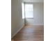 Bright bedroom featuring hardwood floors, base trim and natural light from two windows at 12326 River Valley Dr, Fishers, IN 46037
