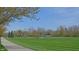 Well maintained community park with mature trees, walking path, and green space at 12326 River Valley Dr, Fishers, IN 46037