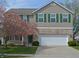 Charming two-story home featuring a brick and vinyl facade, green shutters, and a well-manicured front lawn at 12326 River Valley Dr, Fishers, IN 46037