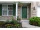 Charming brick home featuring a green front door, well-kept lawn, and lovely landscaping with colorful flowers at 12326 River Valley Dr, Fishers, IN 46037