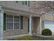 Charming covered front porch and door with brick and siding, and flowering tree at 12326 River Valley Dr, Fishers, IN 46037