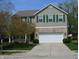 Charming two-story home with attached two car garage, manicured lawn and mature tree at 12326 River Valley Dr, Fishers, IN 46037