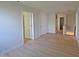 Bright hallway featuring wood-look floors and open doorways to other rooms at 12326 River Valley Dr, Fishers, IN 46037