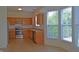 Bright kitchen featuring wood cabinets, stainless steel appliances, and a sunlit bay window at 12326 River Valley Dr, Fishers, IN 46037
