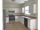 Bright kitchen with white cabinetry, stainless steel appliances and light countertops at 12326 River Valley Dr, Fishers, IN 46037