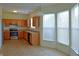 Open kitchen with stainless steel appliances, lots of natural light, light wood cabinets, and tile flooring at 12326 River Valley Dr, Fishers, IN 46037