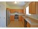 Well-equipped kitchen with stainless steel appliances, light wood cabinets, and a double basin stainless steel sink at 12326 River Valley Dr, Fishers, IN 46037