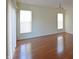 Sun-filled living room featuring sleek hardwood floors and large windows that let in plenty of light at 12326 River Valley Dr, Fishers, IN 46037