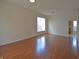 Bright living room with hardwood floors, fresh paint, a large window, and natural light at 12326 River Valley Dr, Fishers, IN 46037