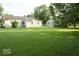 Expansive backyard with lush green grass and a detached shed, perfect for outdoor activities at 126 Mercator Dr, Greenwood, IN 46143
