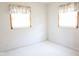 Bright bedroom with white carpet, two windows with blinds and floral valances, and base molding at 126 Mercator Dr, Greenwood, IN 46143