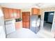 Functional kitchen with wood cabinetry, stainless steel fridge, and adjacent laundry area at 126 Mercator Dr, Greenwood, IN 46143