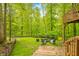View of the backyard with a fire pit and two blue Adirondack chairs at 13306 W 50 S, Columbus, IN 47201