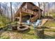 Cozy backyard with an outdoor fireplace surrounded by rustic wooden log seating at 13306 W 50 S, Columbus, IN 47201