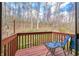 Cozy balcony with seating, offering a private outdoor space to relax and enjoy the serene wooded views at 13306 W 50 S, Columbus, IN 47201