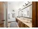 Bright bathroom features a double sink vanity with a large mirror and neutral color palette at 13306 W 50 S, Columbus, IN 47201
