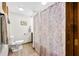 Well-lit bathroom with modern fixtures, light wood-look floors, and a decorative shower curtain at 13306 W 50 S, Columbus, IN 47201