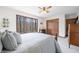 Bedroom with a large window displaying wooded scenery and a comfortable bed with neutral-toned bedding at 13306 W 50 S, Columbus, IN 47201