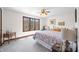 Cozy bedroom features a large window with wooded views, complementing the peaceful and bright atmosphere at 13306 W 50 S, Columbus, IN 47201