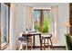 Breakfast nook includes a table, stools, and a large window with a view to the outdoors at 13306 W 50 S, Columbus, IN 47201