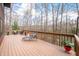 Outdoor deck featuring ample seating and decor, ideal for relaxation and enjoying the scenic woodland backdrop at 13306 W 50 S, Columbus, IN 47201