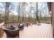 Large wooden deck featuring comfortable seating and decor, perfect for enjoying the peaceful outdoor setting at 13306 W 50 S, Columbus, IN 47201