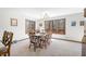 Bright dining room featuring a large window with wooded views at 13306 W 50 S, Columbus, IN 47201