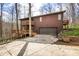 View of a two-story home with a two car garage, brown siding, and a driveway at 13306 W 50 S, Columbus, IN 47201
