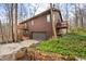 Charming two-story home with a brown exterior, multi-tiered deck, and a convenient attached garage at 13306 W 50 S, Columbus, IN 47201