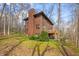 Side view of a two-story home with a chimney and a backdrop of trees at 13306 W 50 S, Columbus, IN 47201