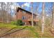 Exterior angle shot of a two-story home surrounded by lush trees and greenery at 13306 W 50 S, Columbus, IN 47201