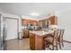 Open concept kitchen with stainless appliances, wood cabinets, and granite countertops at 13306 W 50 S, Columbus, IN 47201