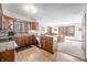 Bright kitchen with wood cabinetry and an adjacent dining area offering serene views of the surrounding woodlands at 13306 W 50 S, Columbus, IN 47201