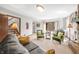 Comfortable living room with a brick fireplace, large windows, and cozy armchairs at 13306 W 50 S, Columbus, IN 47201
