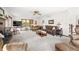 Bright living room with fireplace, comfortable seating, and wooded views at 13306 W 50 S, Columbus, IN 47201