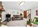 Cozy living room features a leather couch, fireplace, and staircase at 13306 W 50 S, Columbus, IN 47201