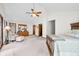 Large main bedroom with vaulted ceilings, wood trim, and a cozy sitting area at 13306 W 50 S, Columbus, IN 47201