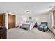 Spacious main bedroom featuring a king-sized bed, reading chair, and natural light at 13306 W 50 S, Columbus, IN 47201