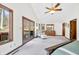 Main bedroom with vaulted ceilings, exterior deck, and wood trim at 13306 W 50 S, Columbus, IN 47201