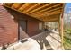 A shot of the outdoor patio, with access door, and partially wooded outdoor view at 13306 W 50 S, Columbus, IN 47201