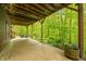 View of a cozy covered porch with a swing and a view of the trees at 13306 W 50 S, Columbus, IN 47201