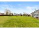 Expansive backyard with lush green lawn and mature trees, offering plenty of space for outdoor activities at 14195 Holly Berry Cir, Fishers, IN 46038