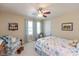 Comfortable bedroom with ceiling fan, natural light, and cozy seating area at 14195 Holly Berry Cir, Fishers, IN 46038