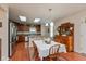 Dining area with wood floors, skylights, and adjacent kitchen at 14195 Holly Berry Cir, Fishers, IN 46038