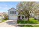 Charming two-story home with a well-manicured lawn and mature tree at 14195 Holly Berry Cir, Fishers, IN 46038