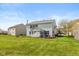 Charming home exterior showcasing a well-maintained yard and a lovely patio area with a fire pit at 14195 Holly Berry Cir, Fishers, IN 46038