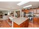 Open kitchen with a kitchen island and views into the living room at 14195 Holly Berry Cir, Fishers, IN 46038