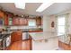Kitchen area boasting wood cabinets and modern stainless steel appliances at 14195 Holly Berry Cir, Fishers, IN 46038